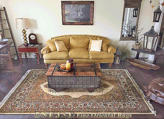 This unique and distinctive Mohtesham 
Kashan rug from Nejad Rugs of Doylestown
is one of the more conservative of Persian 
carpet styles and adheres to a traditional 
format featuring large center medallion 
embellished with stalks of foliage and elegant
floral flourishes as well as the dark rich 
color contrasts of navy, rust and ivory 
reflected in the framed artwork.