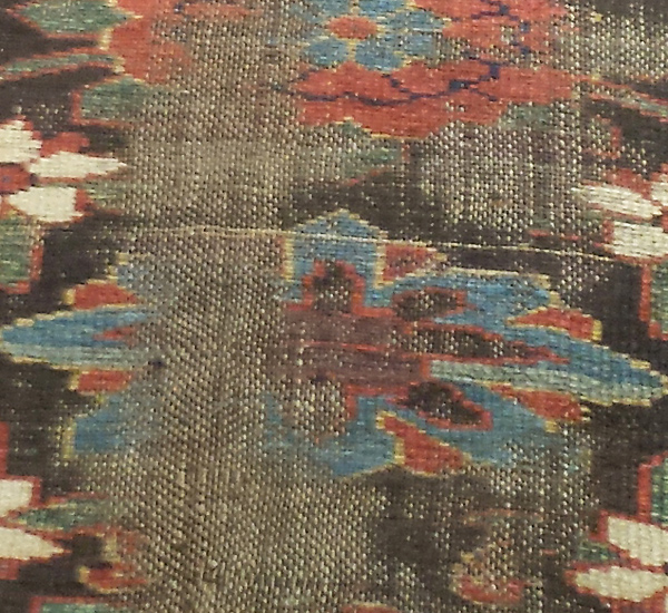 Threadbare center section of rug before repair by Nejad